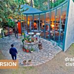 Drained water tank becomes curved, semi-underground home