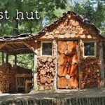 Construction of a house from round timber. Working alone